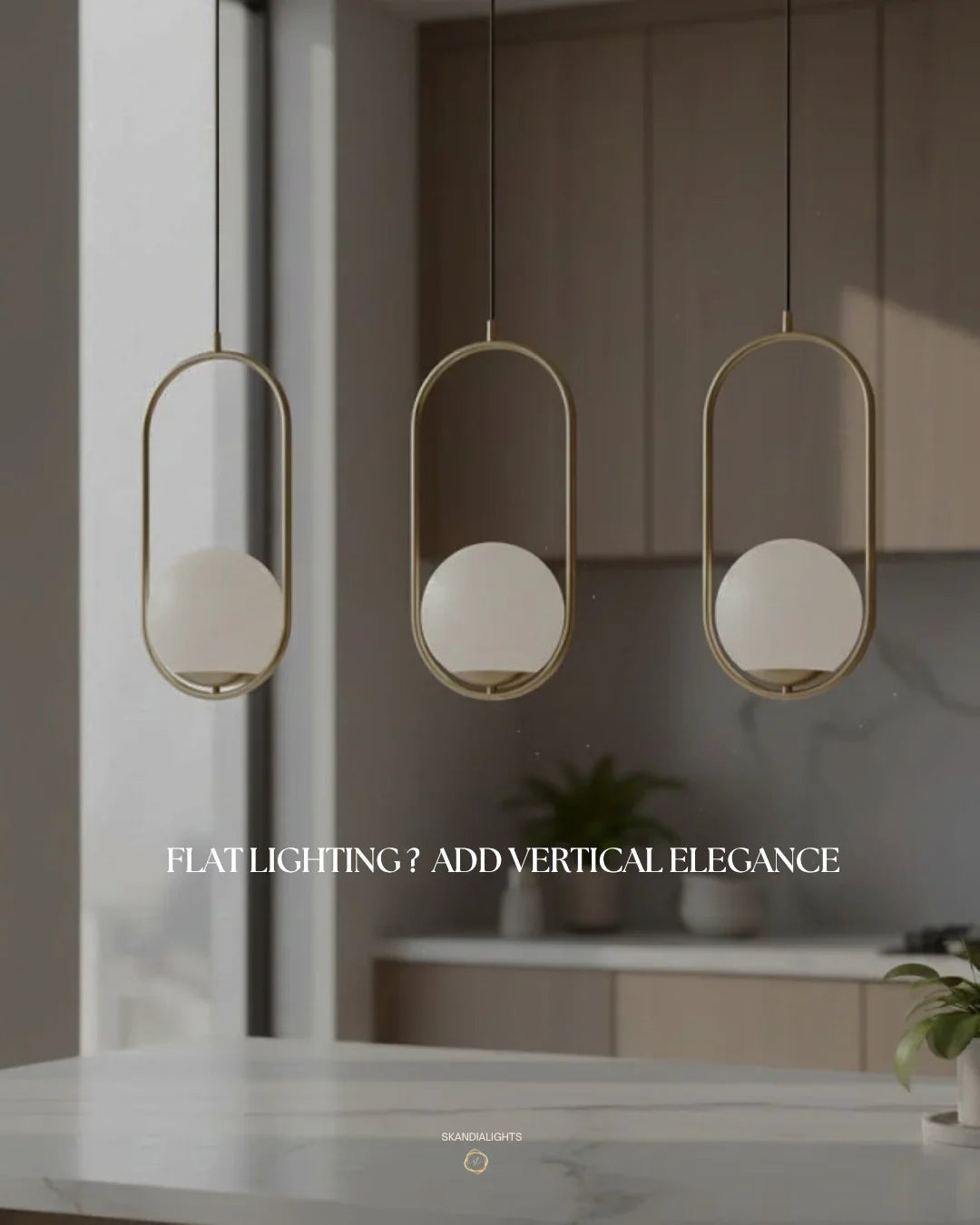 Trio of gold oval Orbital Gem LED pendants above a modern marble kitchen island.